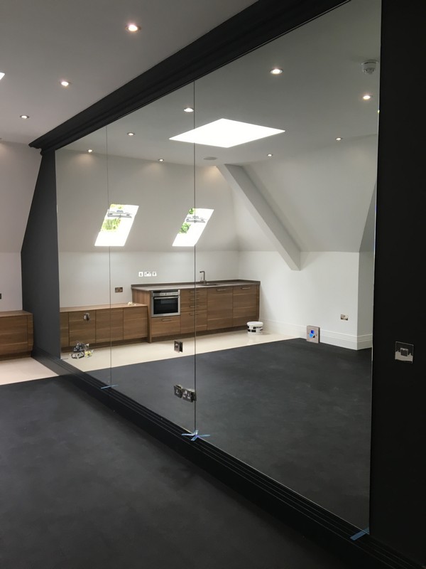 Frameless glass partition in loft conversion by Totteridge glaziers
