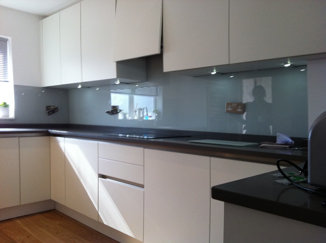 Grey glass kitchen splashback with LED lighting in Totteridge