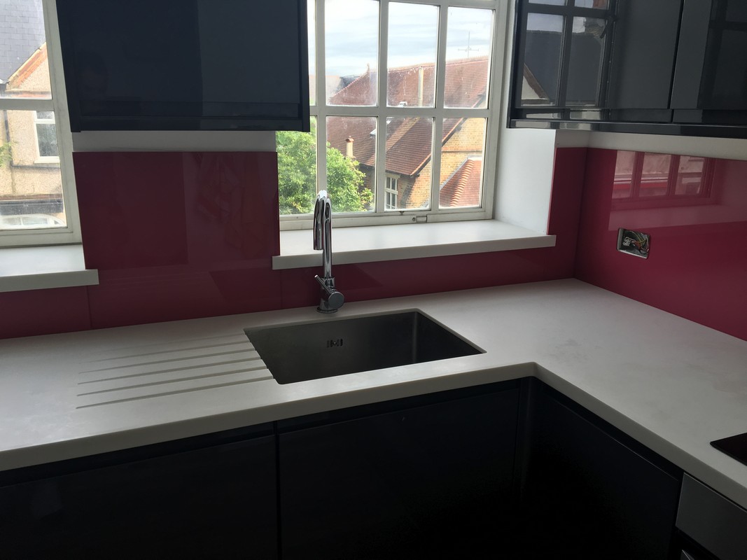 Deep plum coloured glass splashback in modern Totteridge kitchen